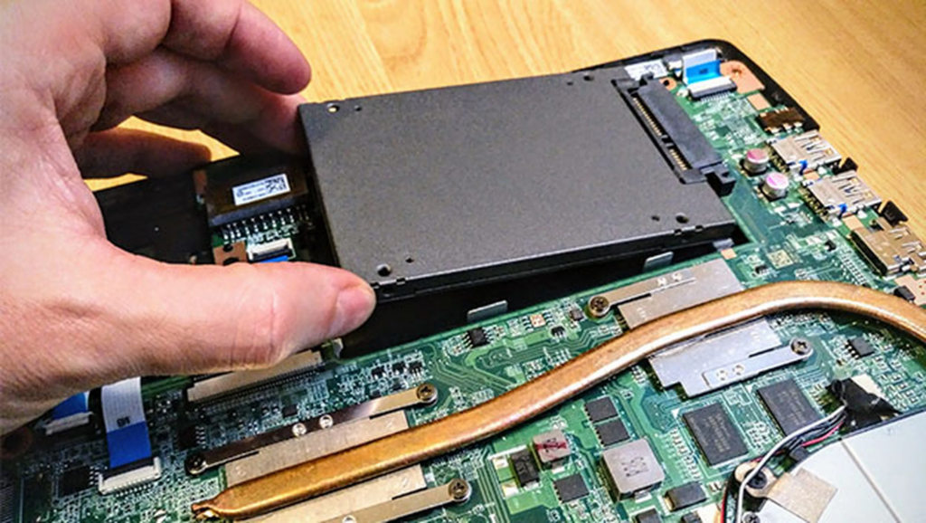 Técnico reemplazando un disco SSD en una notebook